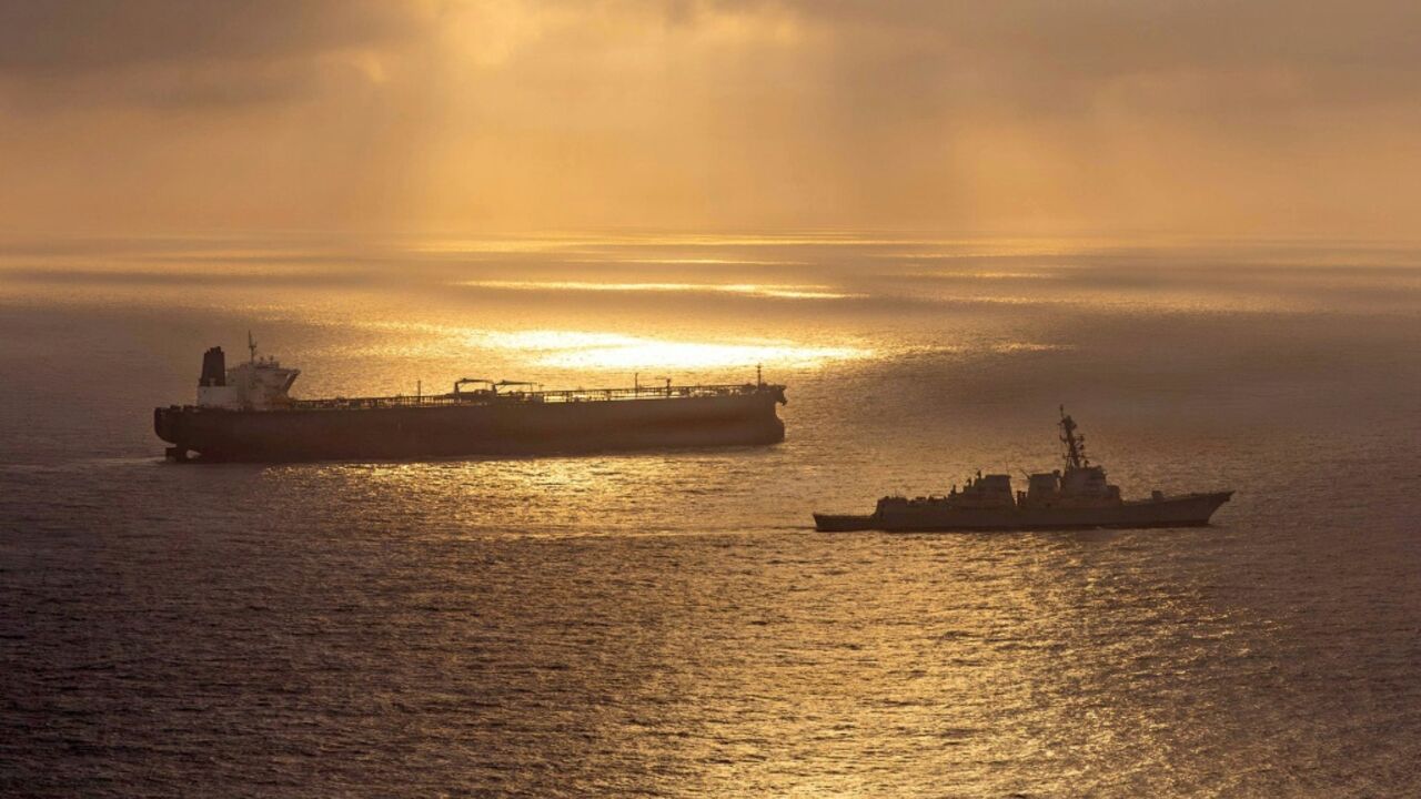 This US Navy handout photo released on May 8 shows the Arleigh Burke-class guided-missile destroyer USS Rafael Peralta (DDG 115) implementing a maritime blockade against the Iran-flagged crude oil tanker vessel Herby
