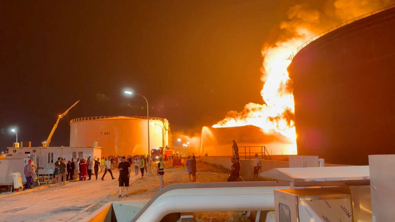 A fire in a storage tank burns as firefighters work to control the blaze, at an oil refinery in Zawiya, Libya August 10, 2026, in this still image from video obtained by Reuters. Video obtained by Reuters/via REUTERS