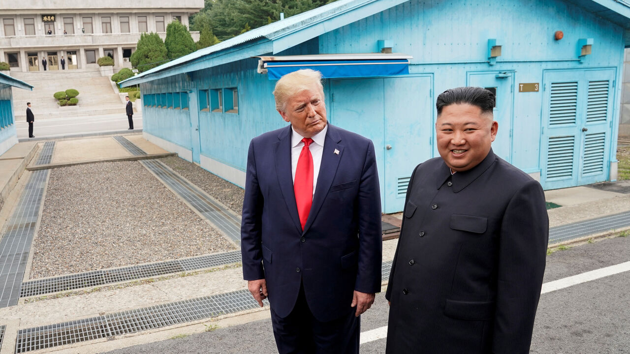 FILE PHOTO: U.S. President Donald Trump meets with North Korean leader Kim Jong Un at the demilitarized zone separating the two Koreas, in Panmunjom, South Korea, June 30, 2019. REUTERS/Kevin Lamarque/File Photo
