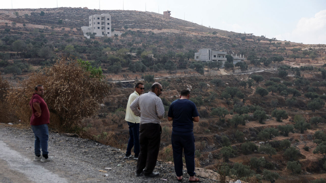 Palestinians look at the houses that came under settler attack, and the Israeli military came there, in the Palestinian village of Qusra in the Israeli-occupied West Bank, August 29, 2026. REUTERS/Ammar Awad