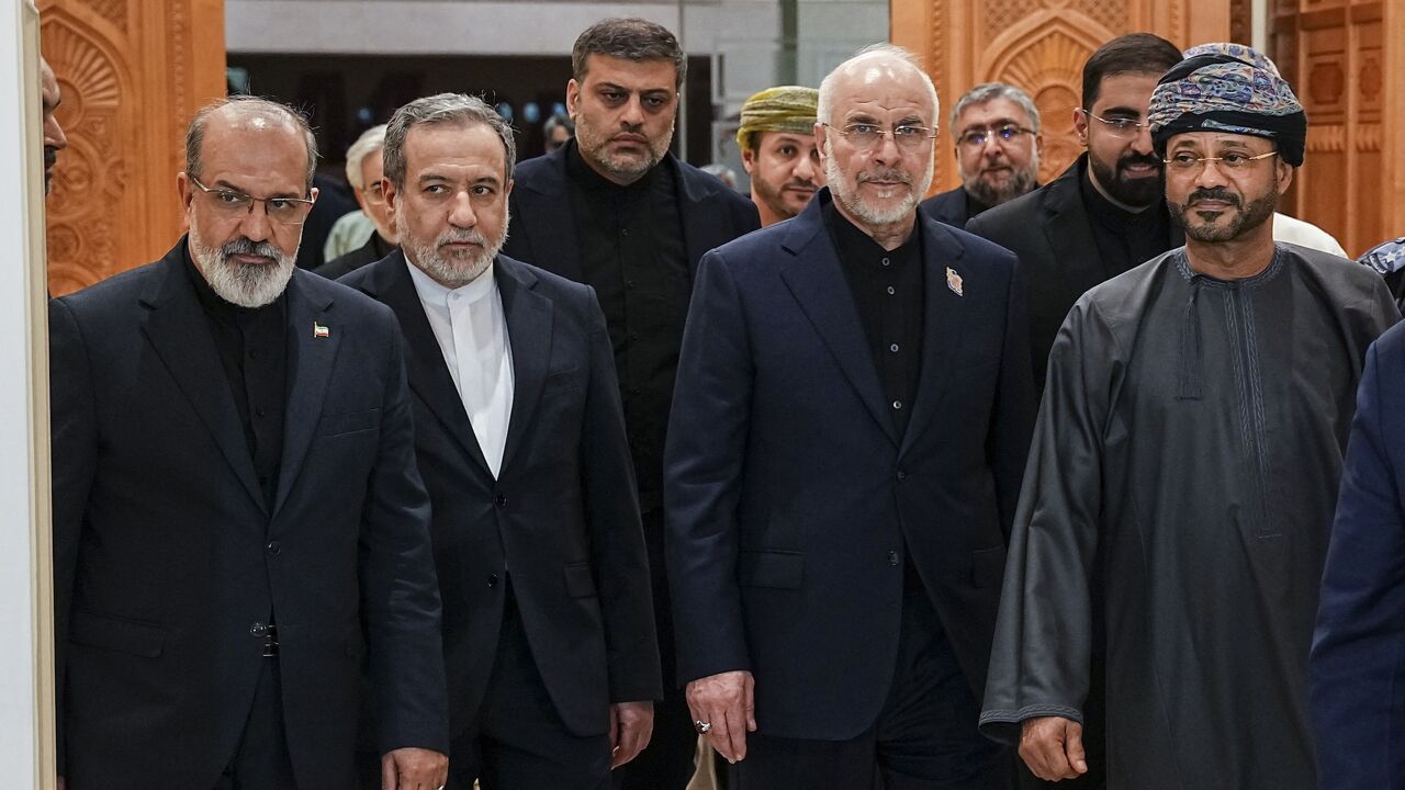 Iranian Foreign Minister Abbas Araghchi (2nd L), Iranian parliament speaker Mohammad Bagher Ghalibaf (2nd R) and Omani Foreign Minister Badr bin Hamad Al-Busaidi (R) walk inside a building in Muscat, Oman, on June 22, 2026. 