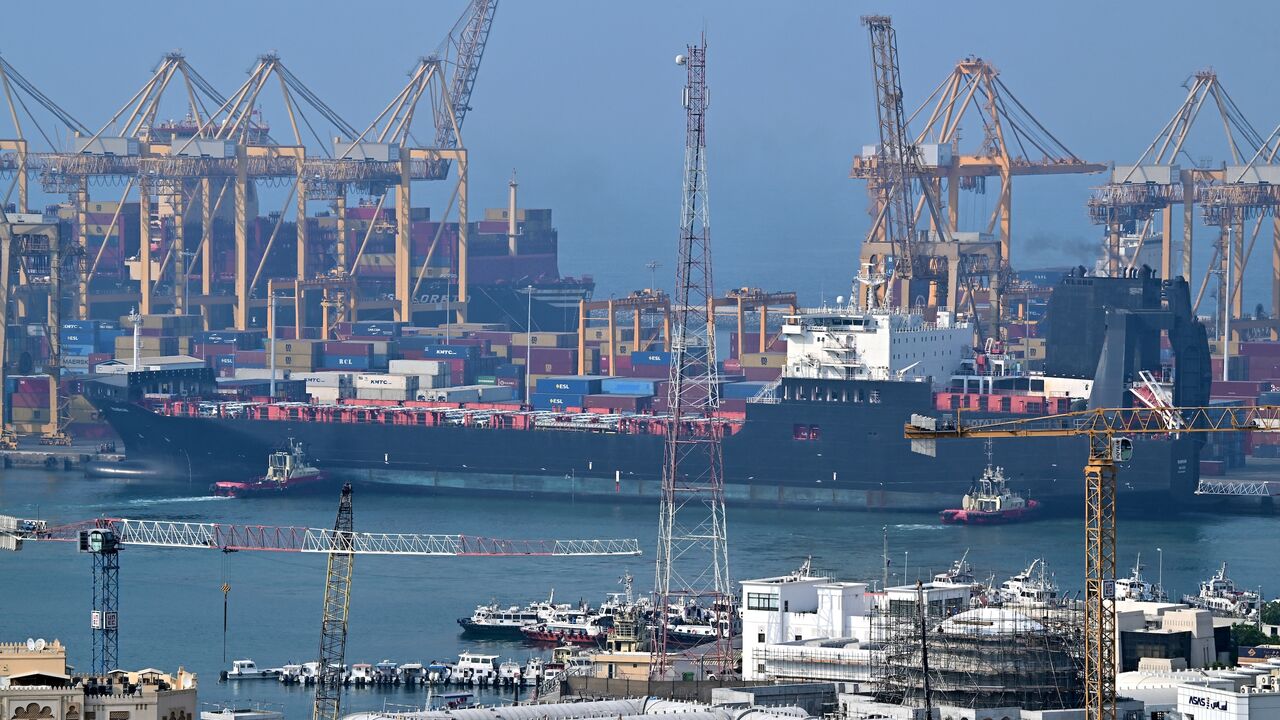 Ships are docked along a pier at the Khor Fakkan Container Terminal, the only natural deep-sea port in the region and one of the major container ports in Sharjah Emirate, along the Gulf of Oman on July 14, 2026. 