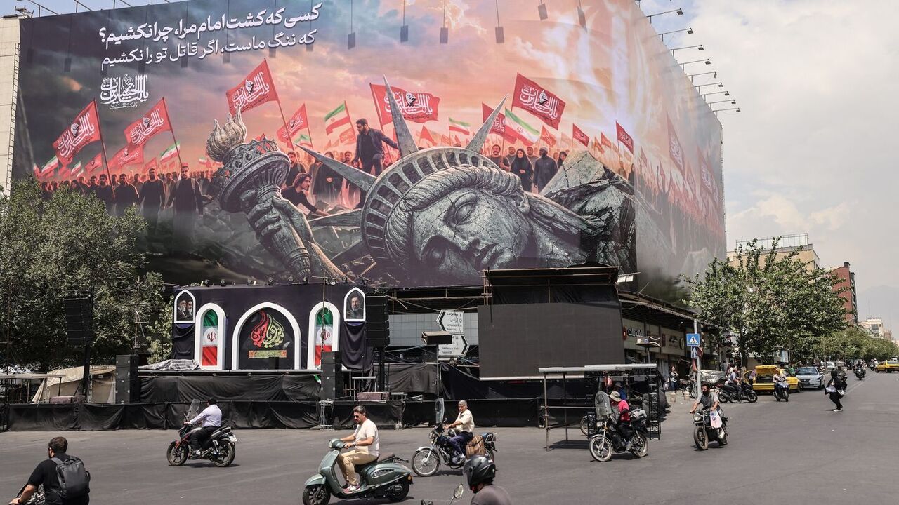 Iranians drive past an anti-US billboard at Enghelab Square in central Tehran, Aug. 3, 2026. — ATTA KENARE / AFP via Getty Images