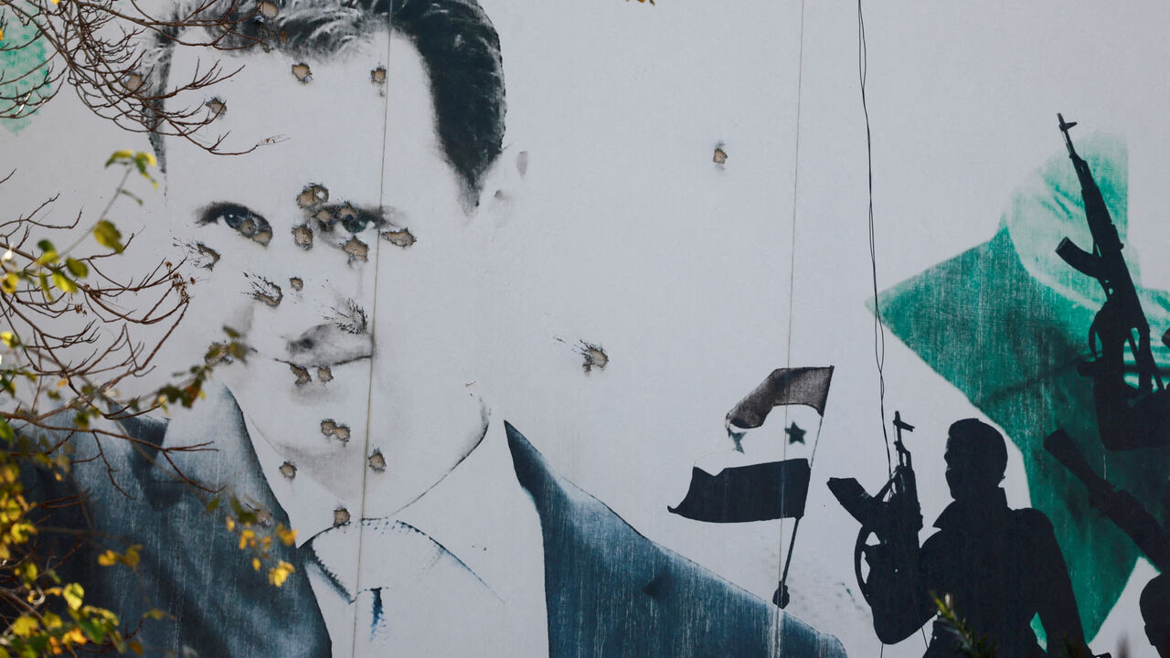 FILE PHOTO: A billboard with a picture of Syria's Bashar al-Assad shows damage by bullet holes, in Damascus, Syria, December 16, 2024. REUTERS/Ammar Awad/File Photo