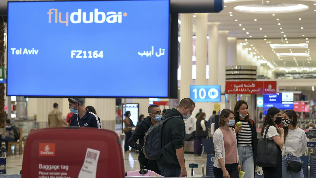 Israelis pick up their luggage upon arrival from Tel Aviv to the Dubai airport in the United Arab Emirates, on Nov. 26, 2020, on the first scheduled commercial flight operated by budget airline flydubai.