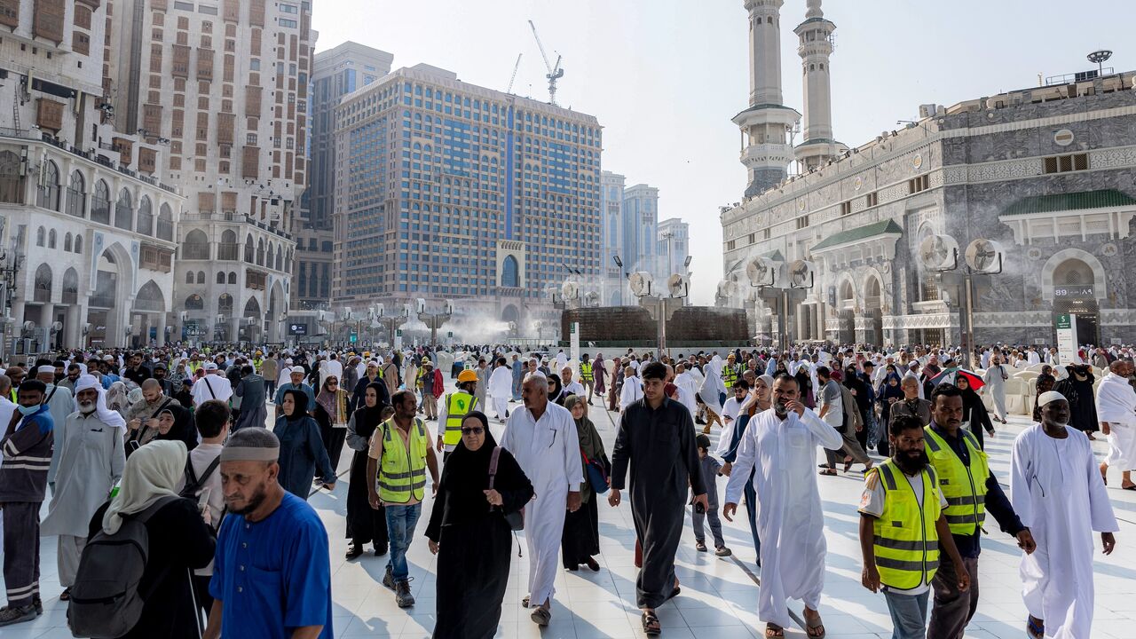 People and pilgrims walk at the Grand Mosque Complex in Saudi Arabia's holy city of Mecca on Sept. 16, 2026.