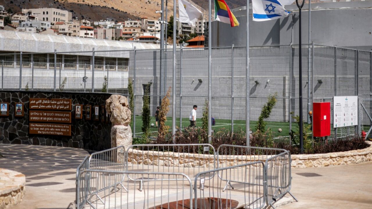 Israeli and Druze flags fly at a memorial site for the 12 child victims killed in a rocket attack that hit a football pitch during the war with Hezbollah in the Druze town of Majdal Shams in the Israeli-annexed Golan Heights