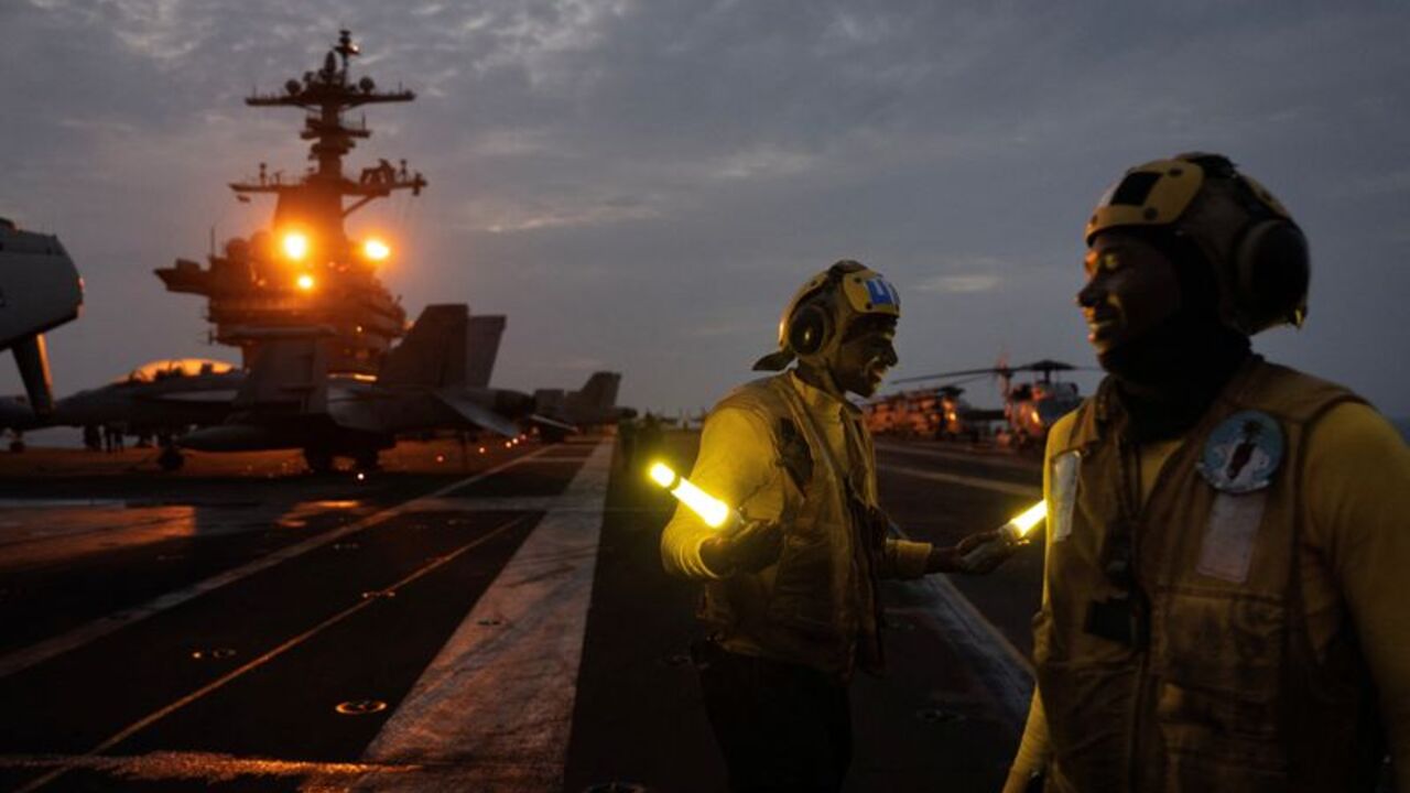 The Wider Image: On the USS George Washington, young sailors adjust to war with Iran