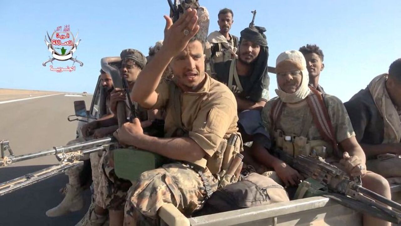 Pro-Saudi-backed Yemeni government fighters sit in the back of a vehicle during what government forces say was an advance against the Iran-backed Houthis, near Dhubab