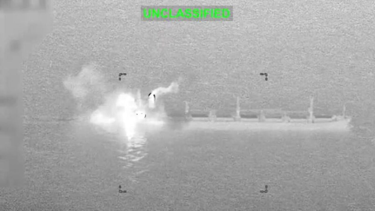 Smoke and fire rise from a commercial cargo vessel following a strike following a US military strike in a location given as the Gulf of Oman
