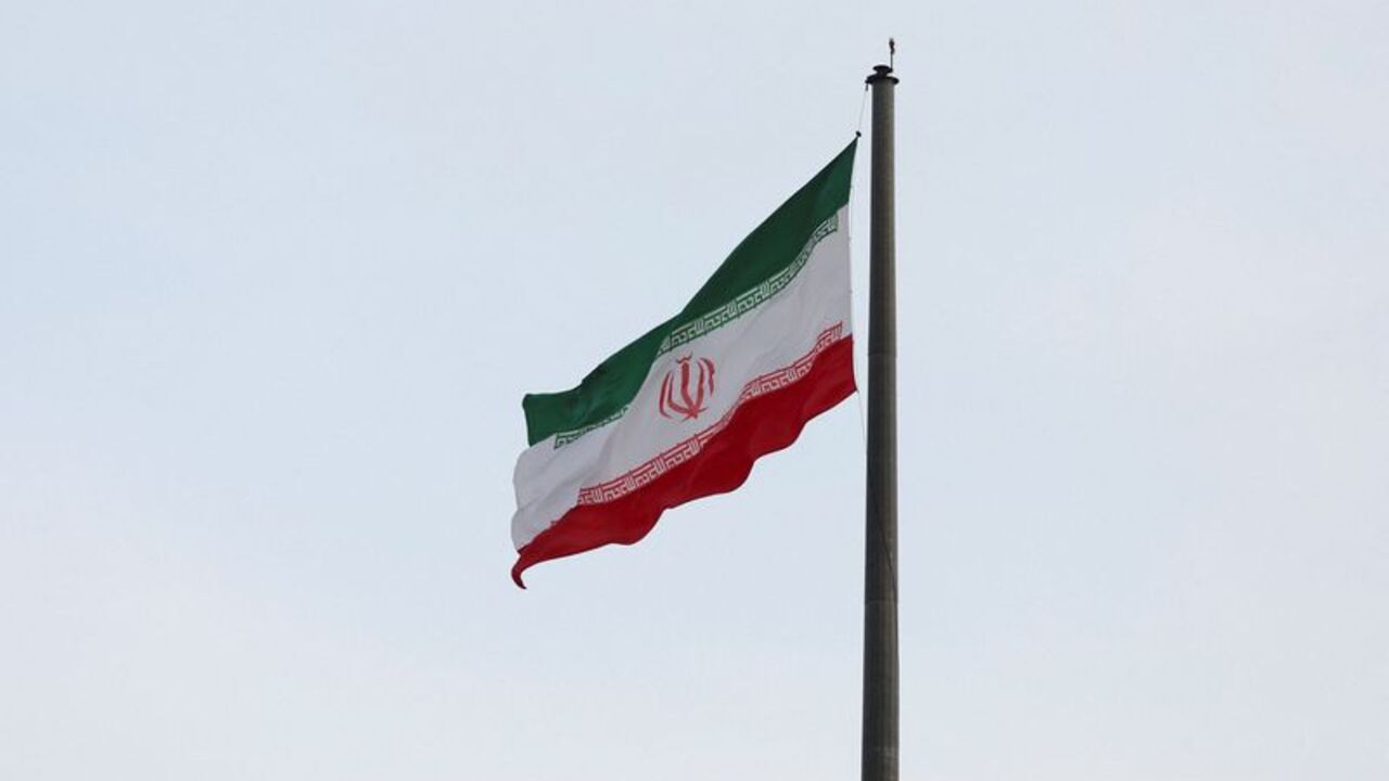 An Iranian flag flutters in a park in Tehran