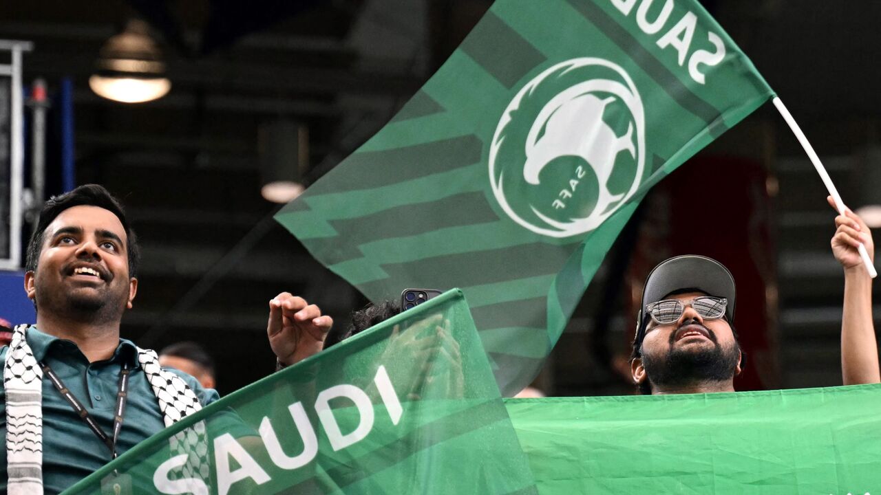 Saudi Arabia football supporters wave flags