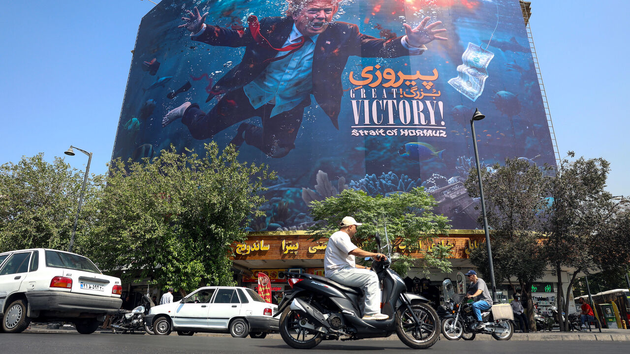 Motorists drive past an anti-US billboard in Tehran on Aug. 24, 2026.