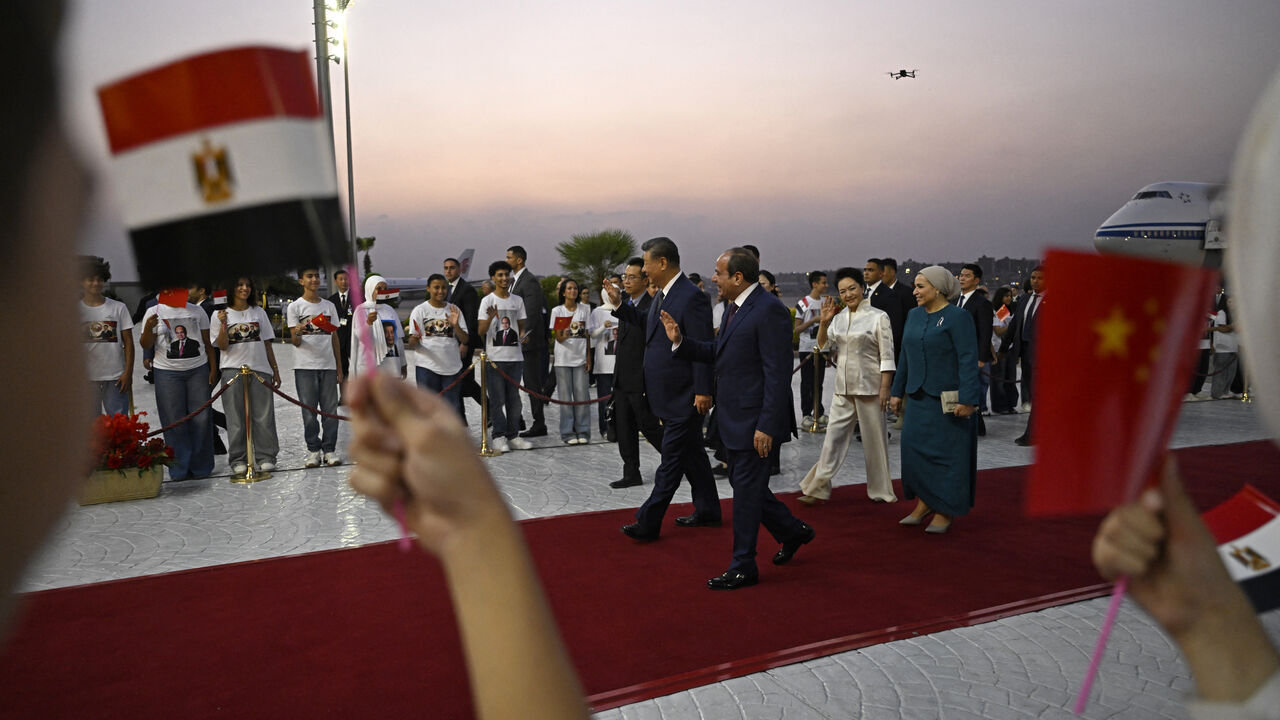China's President Xi Jinping (center L) walks along with his Egyptian counterpart Abdel Fattah al-Sisi followed by their wives Peng Liyuan and Entissar Amer (R) upon their arrival at the Cairo International Airport on September 1, 2026. President Xi Jinping arrived in Egypt on September 1, making a rare trip to the Middle East as both countries face the threat of US sanctions over financial links to Iran. (Photo by Khaled DESOUKI / POOL / AFP via Getty Images)