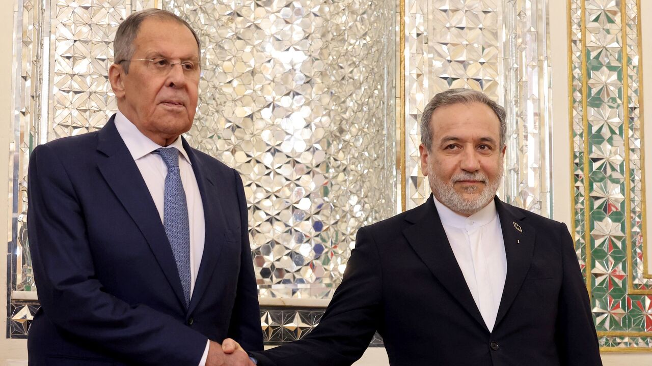 Russian Foreign Minister Sergey Lavrov (L) shakes hands with Iranian Foreign Minister Abbas Araghchi upon his arrival in Tehran on Oct. 19, 2026. 