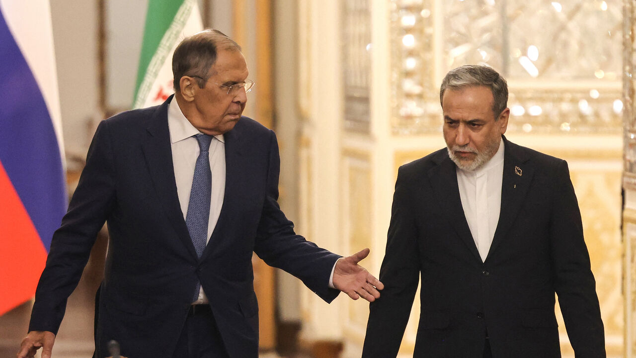 Russia's Foreign Minister Sergey Lavrov (L) and Iran's Foreign Minister Abbas Araghchi arrive to hold a press conference after a meeting in Tehran on October 19, 2026. The Russian foreign minister arrived in Iran on October 19, in his first visit since the outbreak of the Middle East war as Moscow seeks to play a mediating role. (Photo by ATTA KENARE / AFP via Getty Images)