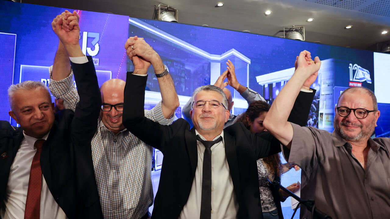 Yousef Jabareen, leader of Israel's Arab-led Joint List political alliance (C-L), and other members cheer at the alliance's campaign headquarters in the northern Israeli city of Nazareth on Oct. 27, 2026. — AHMAD GHARABLI / AFP via Getty Images