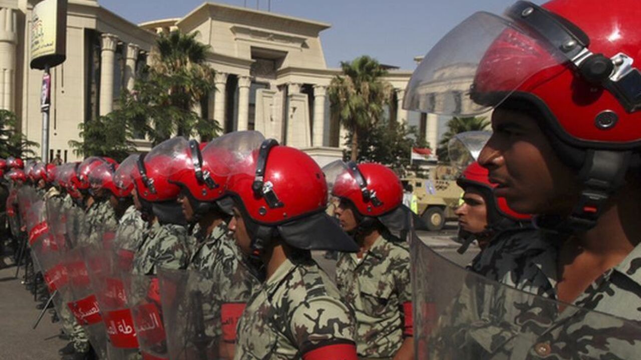 Egyptian military police stand guard outside the Supreme Constitutional Court, where a decision is expected on the validity of the law passed by the Islamist-led parliament that sought to bar Ahmed Shafik, Hosni Mubarak's last prime minister, from the vote Egyptian military police stand guard outside the Supreme Constitutional Court, where a decision is expected on the validity of the law passed by the Islamist-led parliament that sought to bar Ahmed Shafik, Hosni Mubarak's last prime minister, from the vote pitting him against the Muslim Brotherhood's Mohamed Morsy, in Cairo June 14, 2012. Shafik got the green light to continue his bid for Egypt's presidency on Thursday when a constitutional court ruled against a law that would have thrown him out of the rac
