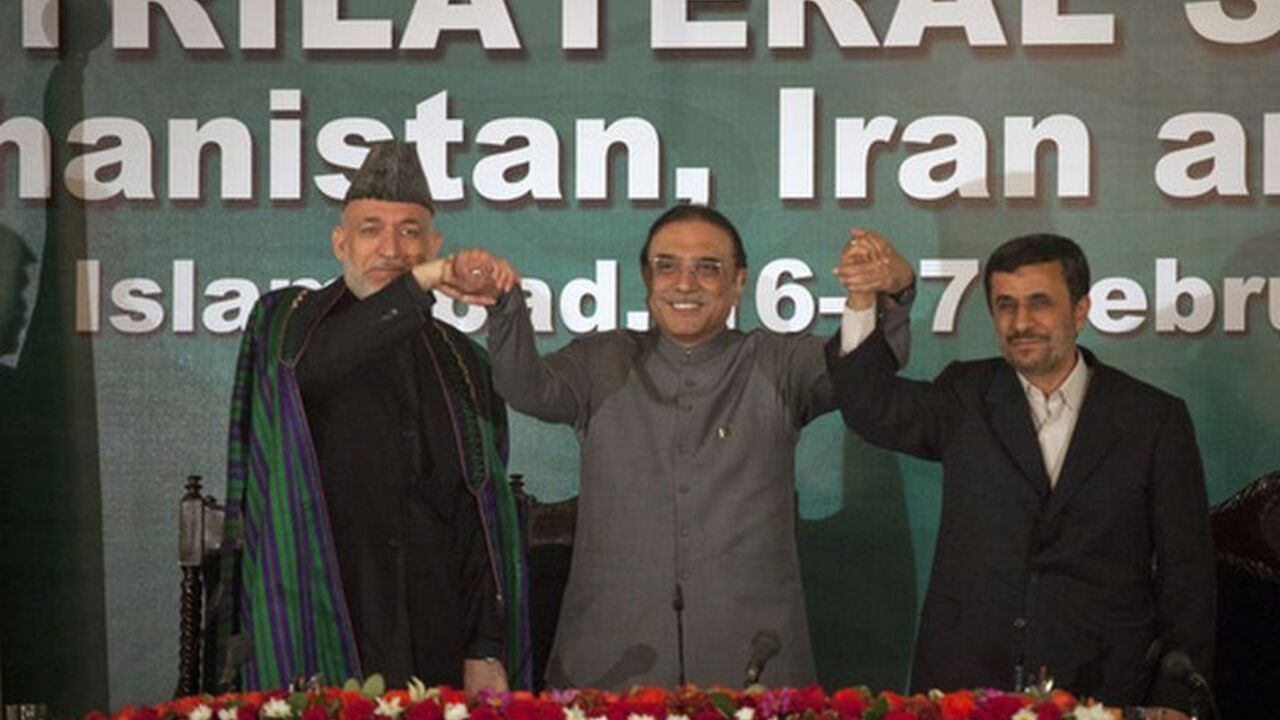 Afghanistan's President Karzai, Pakistan's President Zardari and Iran's President Ahmadinejad join hands after a news conference in Islamabad Afghanistan's President Hamid Karzai (L), Pakistan's President Asif Ali Zardari (C) and Iran's President Mahmoud Ahmadinejad join hands after a news conference in Islamabad February 17, 2012. Ahmadinejad, accused by the West of pursuing a nuclear weapons programme, said in Pakistan on Friday foreign nations were determined to dominate the region and this should not be allowed. REUTERS/Mian Khursheed (PAKISTAN - Tags: POLITICS)