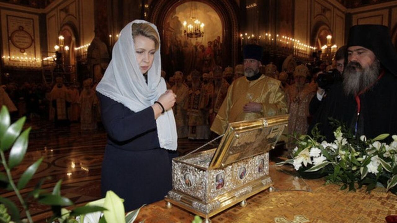 Russia's First Lady Svetlana Medvedeva crosses herself in front of a chest containing the Cincture of the Virgin Mary during a service at the Cathedral of Christ the Saviour in Moscow Russia's First Lady Svetlana Medvedeva (L front) crosses herself in front of a chest containing the Cincture of the Virgin Mary during a service at the Cathedral of Christ the Saviour in Moscow November 19, 2011. Orthodox Christians believe that one can be cured from serious diseases by touching the holy relic. According to legend, the holy relic was a belt made from camel wool by the Virgin Mary, and was part of her dress. The holy relic was brought to Russia from Vatopedi monastery in Greece, and has trav