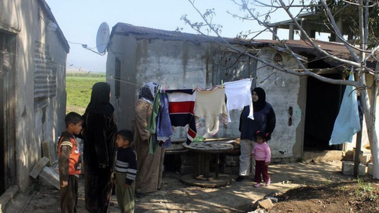 Syrian refugees who have fled the violence in Syria stand at a temporary home at Wadi Khaled in northern Lebanon Syrian refugees who have fled the violence in Syria stand at a temporary home at Wadi Khaled in northern Lebanon April 4, 2012. REUTERS/Roula Naimeh (LEBANON - Tags: CIVIL UNREST)