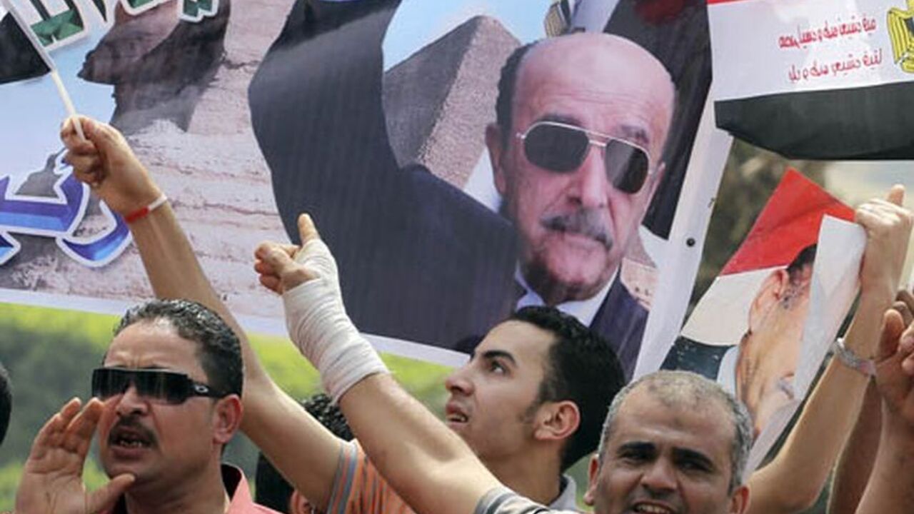 EGYPT Supporters of presidential candidate and Egypt's former vice president Omar Suleiman, cheer while carrying banners bearing images of him, as Suleiman presented recommendation documents to the Higher Presidential Elections Commission (HPEC) headquarters in Cairo April 8, 2012.The intelligence chief of Egypt's deposed leader Hosni Mubarak formally joined the race for the presidency on Sunday, a last-minute entrance that raises the heat in a contest pitting former regime figures against newly-assertive Islamis