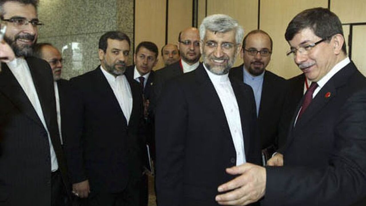 NUCLEAR-IRAN/TALKS Turkey's Foreign Minister Ahmet Davutoglu (R) welcomes Iran's chief negotiator Saeed Jalili (2nd R) before their meeting in Istanbul April 14, 2012. World powers and Iran launched a new round of negotiations in Istanbul on Saturday, aiming to resolve a long-standing dispute over Tehran's nuclear programme that threatens to spark a new war in the Middle East. REUTERS/Hakan Goktepe/Pool (TURKEY - Tags: POLITICS)
