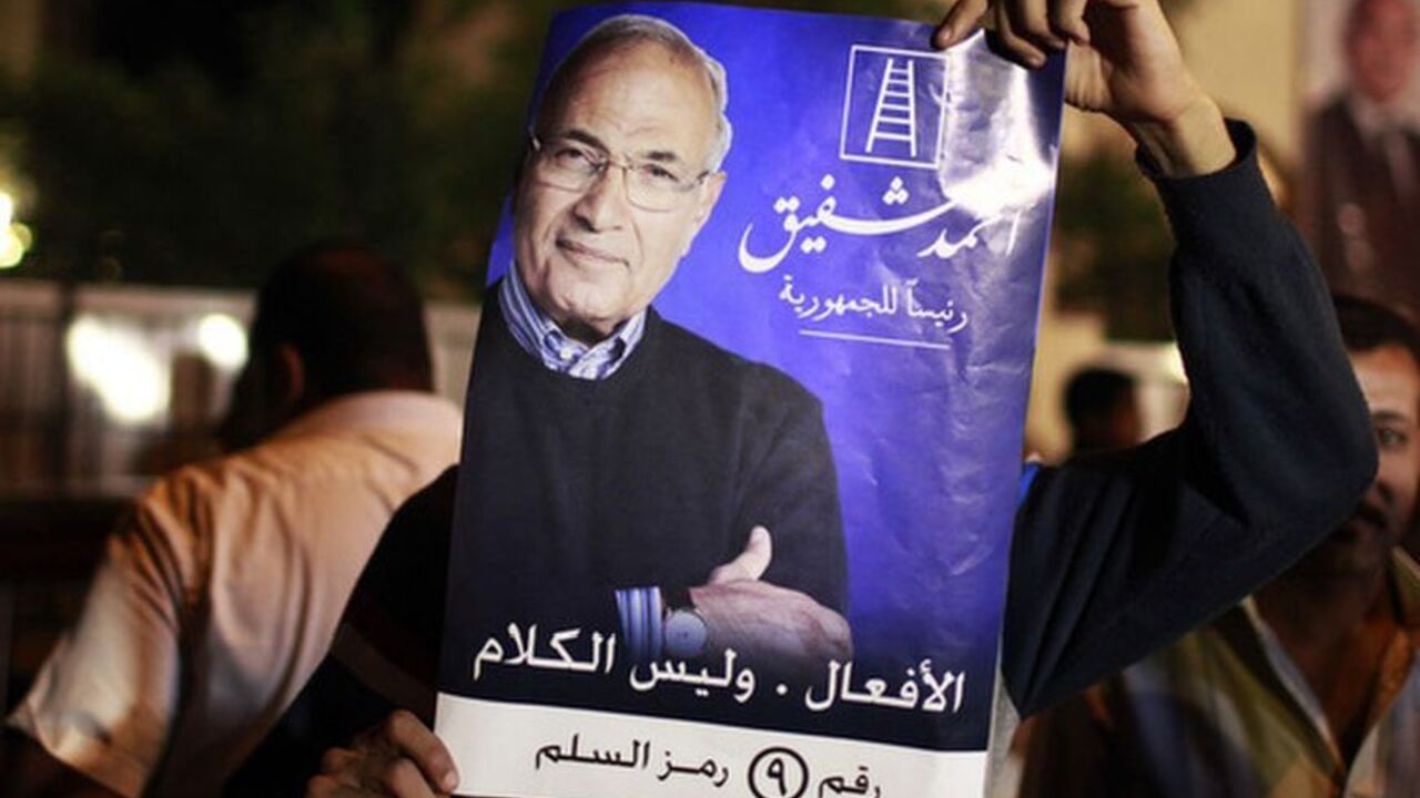 Supporter of candidate Ahmed Shafiq holds his picture as he celebrates in Cairo A supporter of candidate Ahmed Shafiq holds his picture as he celebrates in Cairo May 25, 2012. The prospect of Shafiq succeeding Hosni Mubarak as president of Egypt is a nightmare for revolutionaries and Islamists, but a security blanket for those wary of change. REUTERS/Suhaib Salem (EGYPT - Tags: POLITICS CIVIL UNREST)