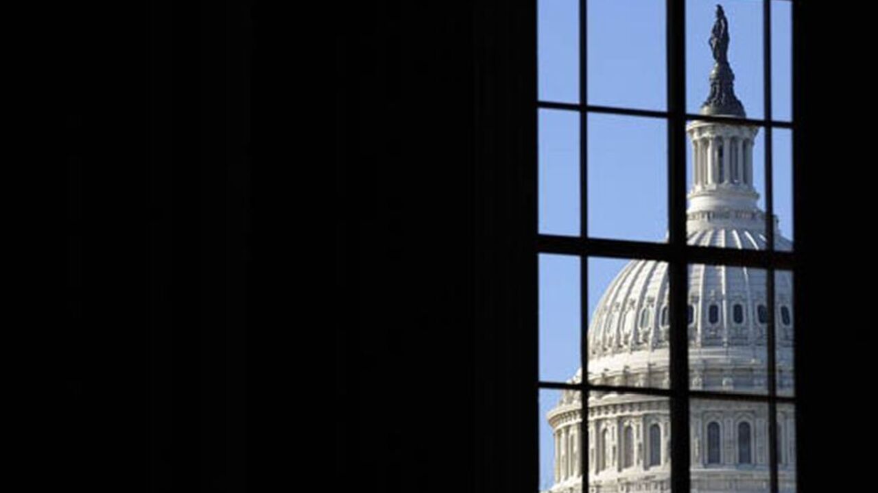 USA/ The dome of the US Capitol, where President Barack Obama will deliver his first address to a joint session of congress, is visible through a window on Capitol Hill in Washington, February 24, 2009. REUTERS/Jonathan Ernst (UNITED STATES)