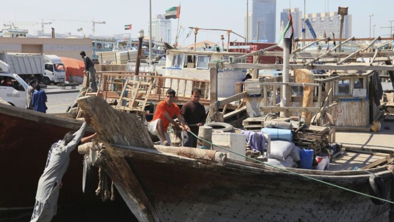 To match Feature IRAN-TRADE Workers load goods onto ships at the port in Deira, February 27, 2012. Financial sanctions imposed over Iran's disputed nuclear programme have dealt a heavy blow to its foreign trade. Since late last year the United States has stepped up its use of anti-money laundering legislation to make it legally dangerous for banks that have any U.S. business to maintain ties with Iran. As a result, Iranian firms have been frozen out of much of the global banking system which finances trade. It is difficult or impossib