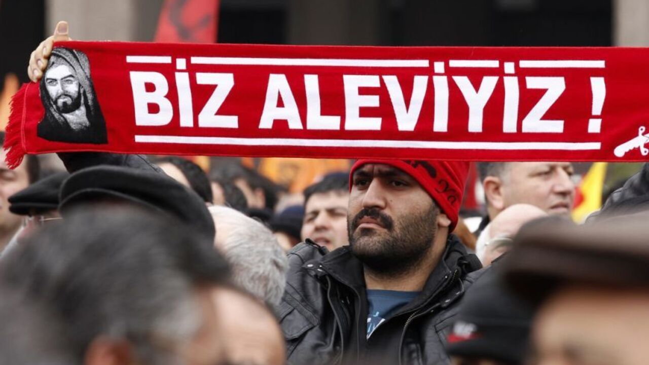 A protester holds a banner reading "we are alevi" as he and many others wait to hear the decision of the court in front of a courthouse in Ankara A protester holds a banner reading "we are alevi" as he and many others wait to hear the decision of the court in front of a courthouse in Ankara March 13, 2012. Turkish police fired tear-gas and water cannon to disperse hundreds protesting on Tuesday against the dropping of a case against five people charged with killing 37 writers and liberals in a 1993 hotel fire set off by Islamist rioters.The opposition accused Prime Minister Tayyip Erdogan and his AK Party, which emerged from a series of banned Islami