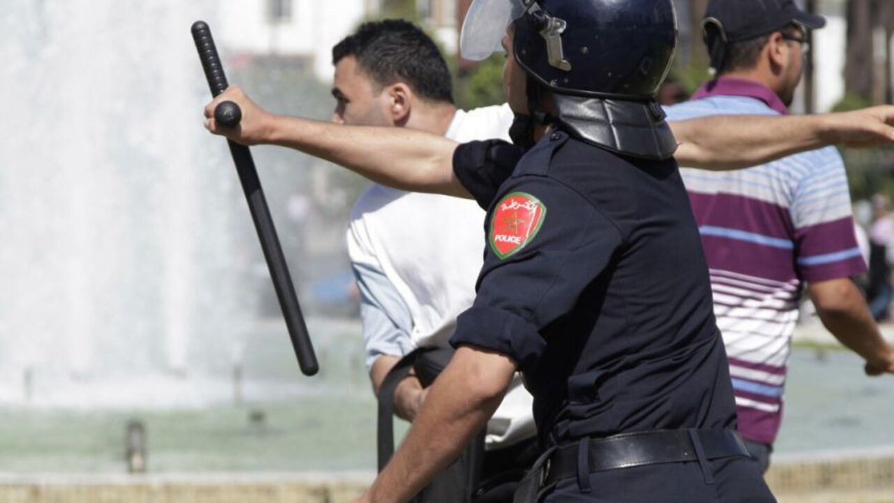 A police officer clashes with a protester during a demonstration in Rabat A police officer clashes with a protester, as police attempt to disperse anti-government protesters and young unemployed graduates, during a demonstration in Rabat September 20, 2012. REUTERS/Stringer (MOROCCO - Tags: POLITICS CIVIL UNREST BUSINESS EMPLOYMENT TPX IMAGES OF THE DAY)