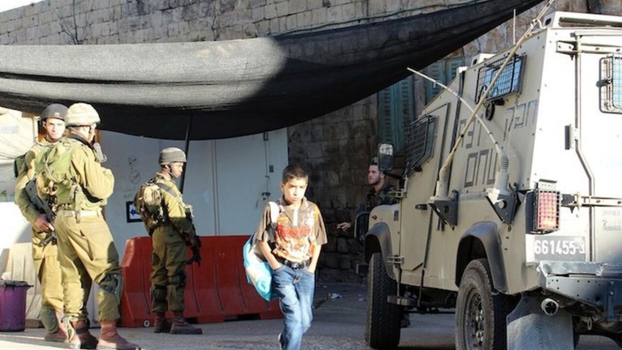 1-boy walks through checkpoint.jpg