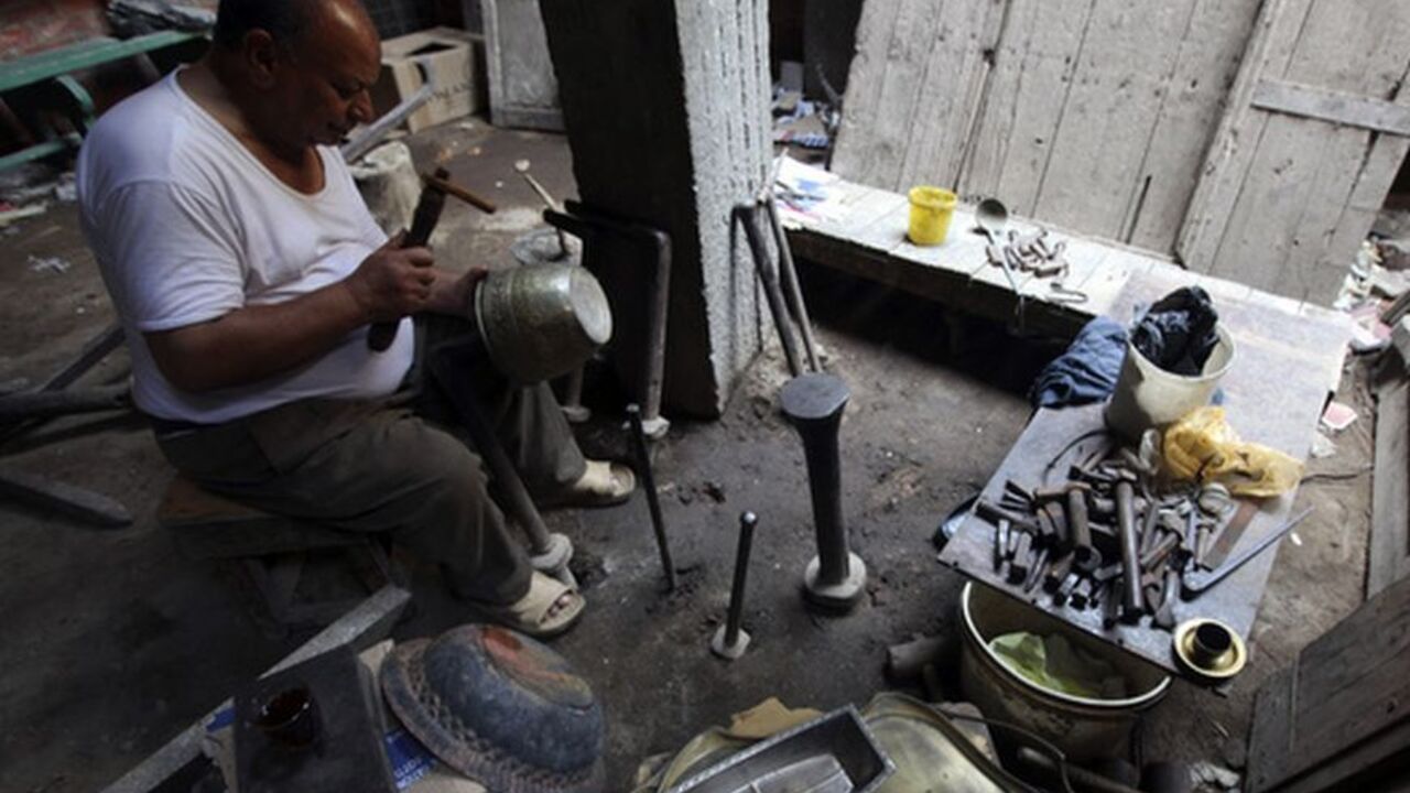Hag Mohamed ,65, works at his copper workshop at the market of Khan el-Khalili in the old city of Cairo Hag Mohamed ,65, works at his copper workshop at the market of Khan el-Khalili in the old city of Cairo June 15, 2012. Activists called for a protest on Friday and Islamists warned that the gains of the revolt that toppled Hosni Mubarak could be wiped out after Egypt's supreme court dissolved parliament and ruled to keep his last premier in this weekend's presidential race. REUTERS/Amr Abdallah Dalsh (EGYPT - Tags: POLITICS CIVIL UNREST ELECTIONS)