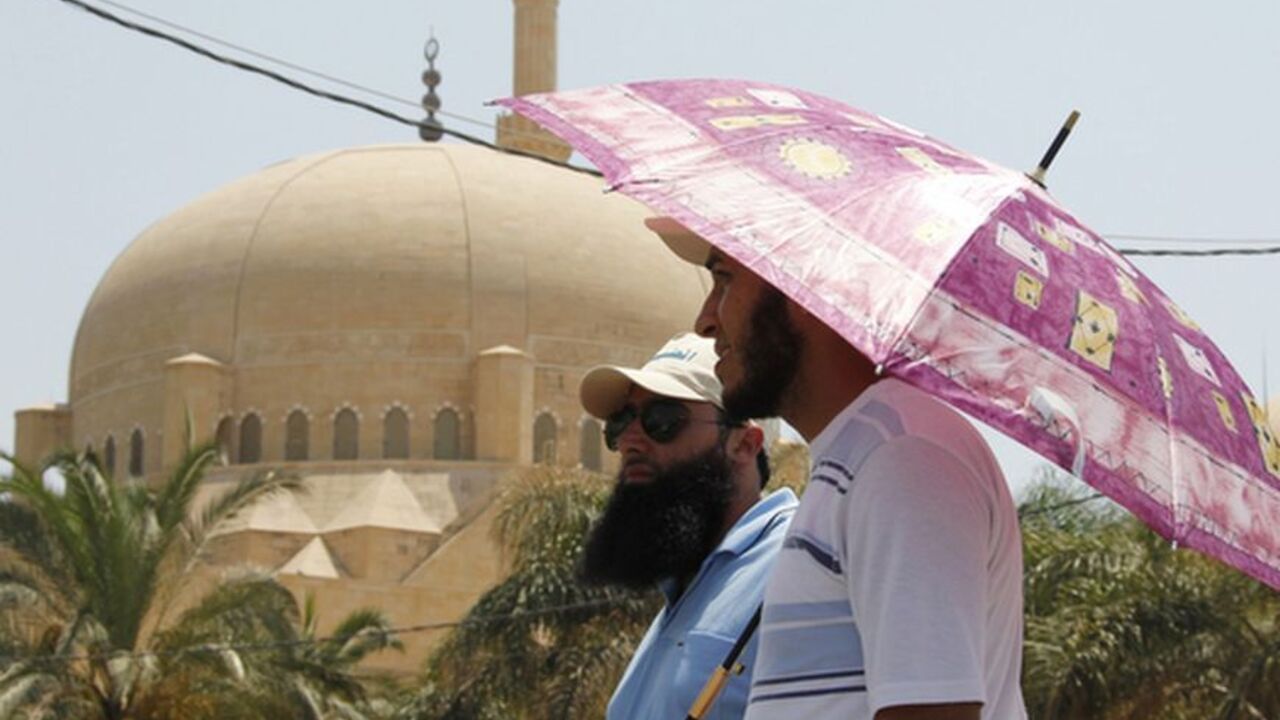 Supporters of Sunni Muslim Salafist leader Ahmad al-Assir stand under an an umbrella at an open-ended sit-in in Sidon, southern Lebanon Supporters of Sunni Muslim Salafist leader Ahmad al-Assir stand under an an umbrella at an open-ended sit-in in Sidon, southern Lebanon, June 29, 2012. Lebanese Sunni Muslim Salafists are holding an open-ended sit-in after their leader Sheikh Ahmad al-Aseer called on Lebanese armed parties - especially Shi'ite Hezbollah - to give up their arms and have the army and the security forces be the sole possessors of arms in the country. REUTERS/Ali Hashisho (LEBANON - Tags: POLITICS CIVIL UNREST)