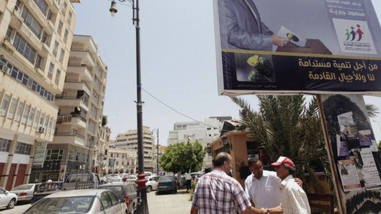Men shake hands near election campaign poster of candidate running for election to Libya's National Congress, Mahmoud Jibril, head of National Forces Alliance, in Benghazi Men shake hands near an election campaign poster of a candidate running for election to Libya's National Congress, Mahmoud Jibril, head of the National Forces Alliance, in Benghazi July 9, 2012. International observers declared Libya's landmark national assembly election a success on Monday, concluding that violent incidents and anti-vote protests in the restive east failed to stop Libyans from turning out in large numbers. REUTERS/Esam Al-Fetori (LIBYA - Tags: POLITICS ELECTIONS)