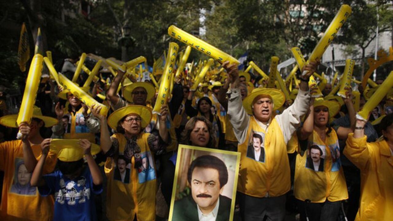 A woman holds a picture of Iranian resistance leader Rajavi as supporters of the main Iranian opposition, the Mujahedin-e Khalq, protest against Iranian President Ahmadinejad's visit to the U.N. in New York A woman holds a picture of Iranian resistance leader Massoud Rajavi as supporters of the main Iranian opposition, the Mujahedin-e Khalq, protest against Iranian President Mahmoud Ahmadinejad's visit to the U.N. outside the U.N. headquarters in New York September 22, 2011. REUTERS/Eduardo Munoz (UNITED STATES - Tags: POLITICS)