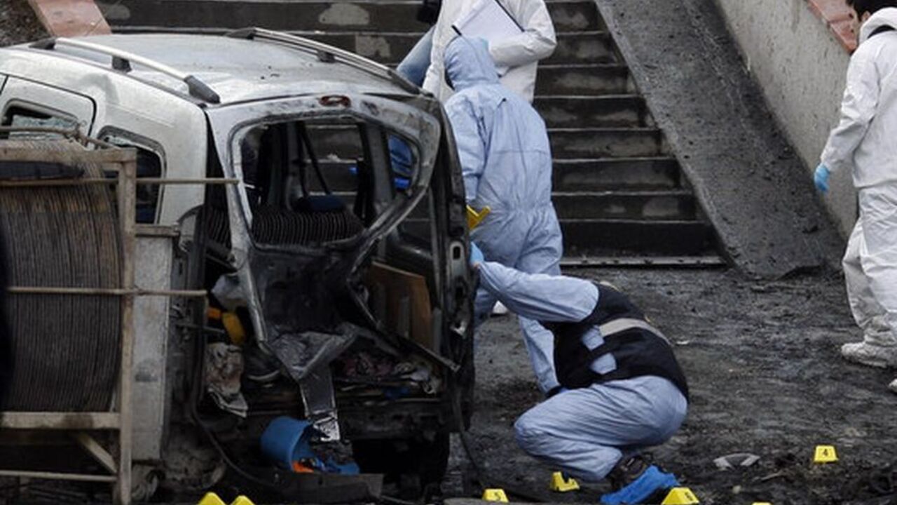 Police forensic officers inspect the scene of a bombing near police vehicles in Istanbul Police forensic officers inspect the scene of a bombing near police vehicles in Istanbul March 1, 2012. A remote control bomb injured 10 police officers on Thursday as their vehicle passed close to the Istanbul headquarters of Turkey's ruling AK Party, Turkish police said. Istanbul police chief Huseyin Capkin said the device was placed on a motorcycle and set off by remote control as a police vehicle drove past, near the AK Party building and the offices of a conservative business association. REUTERS/Osm