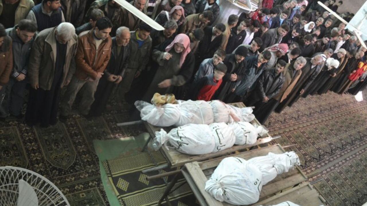 Residents pray near the bodies of people whom activists said were killed during fighting with forces loyal to Syria's President Bashar Al-Assad at Marat AL-Numan, during their funeral in Kafranbel, near Idlib December 26, 2012. REUTERS/Raed Al-Fares/Shaam News Network/Handout (SYRIA - Tags: POLITICS CIVIL UNREST CONFLICT)