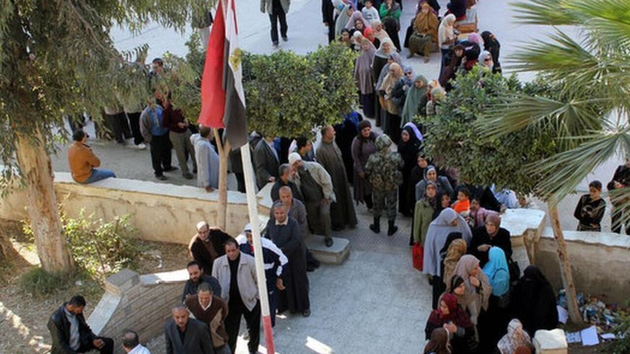 Lines of male and female voters wait at the yard of Al-Qadima Elemenrary School in Egypt's Monofeya to cast their ballots in the second phase of the constitutional referendum held on Saturday Dec. 22, 2012.