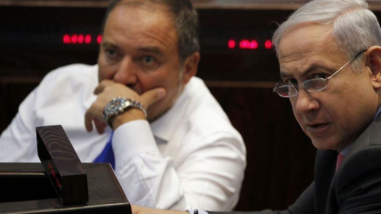 Israel's Prime Minister Netanyahu and Foreign Minister Lieberman attend a session of the Knesset, the Israeli parliament, in Jerusalem Israel's Prime Minister Benjamin Netanyahu (R) and Foreign Minister Avigdor Lieberman attend a session of the Knesset, the Israeli parliament, in Jerusalem August 3, 2011. Israel's parliament passed a law on Wednesday aimed at cutting housing prices, but protesters seeking wider economic reforms pledged to step up their campaign against rising living costs. Netanyahu has been under pressure in the past few weeks to lower living costs in what local media have dubbed an uprising of the middle class. REUTERS/B