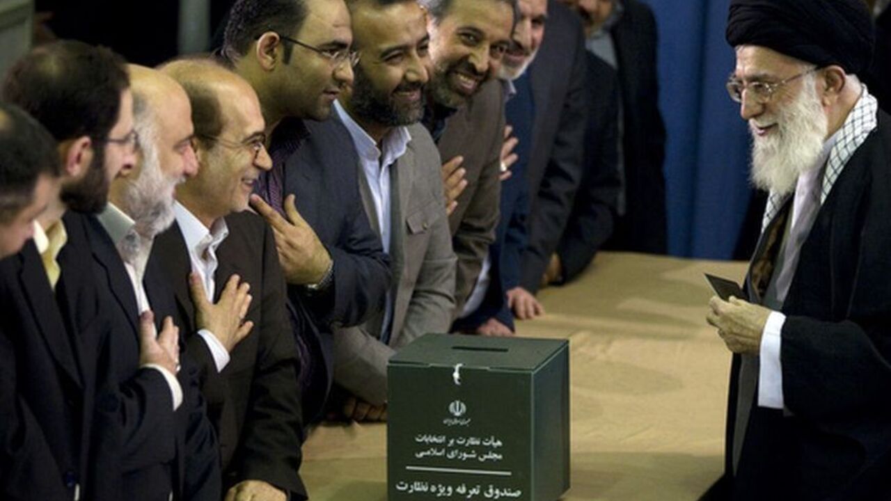 Iran's Supreme Leader Ayatollah Khamenei greets election officials as he presents his identification papers to cast his ballot in the parliamentary election in Tehran Iran's Supreme Leader Ayatollah Ali Khamenei greets election officials as he presents his identification papers to cast his ballot in the parliamentary election in Tehran March 2, 2012. Polls opened on Friday for a parliamentary election in Iran that will test the popularity of the clerical establishment at a time of a standoff with the West over the country's nuclear programme. REUTERS/Caren Firouz (IRAN - Tags: POLITICS ELECTIONS TPX IMAGES OF THE DAY)