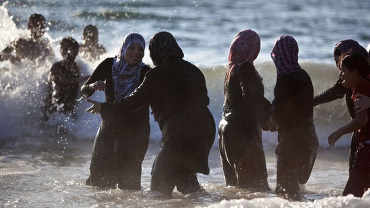 Palestinian women enjoy themselves at a beach in Tel Aviv during Eid al-Fitr Palestinian women enjoy themselves at a beach in Tel Aviv during Eid al-Fitr, which marks the end of the holy month of Ramadan August 20, 2012. A spokesperson for The Israeli Coordinator for Government Activities in the Territories' (COGAT) said that improved security had allowed for the entry of over 1 million Palestinians from the occupied West Bank since the beginning of Ramadan. REUTERS/Nir Elias (ISRAEL - Tags: RELIGION SOCIETY)