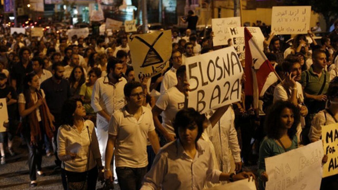 Lebanese protesters hold banners during the "White March" against the violence and the political struggle in the country, organised by Lebanese civil society groups, in Beirut Lebanese protesters hold banners during the "White March" against the violence and the political struggle in the country, organised by Lebanese civil society groups, in Beirut October 25, 2012. REUTERS/Jamal Saidi (LEBANON - Tags: POLITICS CIVIL UNREST)