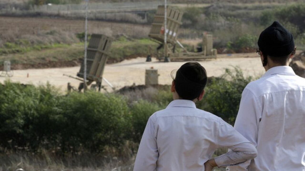 Ultra-Orthodox Jewish youths look at an Iron Dome anti-missile battery near Tel Aviv Ultra-Orthodox Jewish youths look at an Iron Dome anti-missile battery near Tel Aviv November 19, 2012. Israel bombed dozens of targets in Gaza on Monday and said that while it was prepared to step up its offensive by sending in troops, it preferred a diplomatic solution that would end Palestinian rocket fire from the enclave. REUTERS/Baz Ratner (ISRAEL - Tags: CIVIL UNREST POLITICS MILITARY)