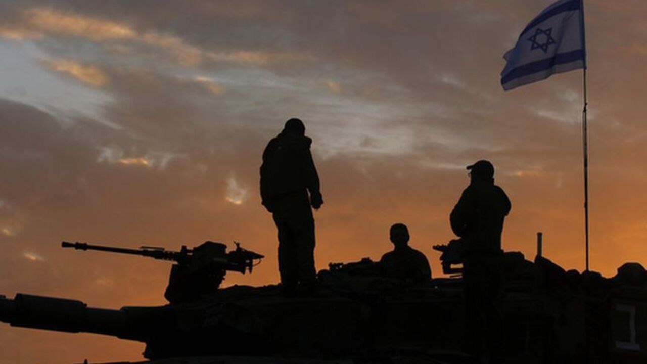 Israeli soldiers atop a tank at the Gaza border Israeli soldiers, atop a tank, prepare to leave their Gaza border position at sun rise November 22, 2012. A ceasefire between Israel and Gaza's Hamas rulers took hold on Thursday after eight days of conflict, although deep mistrust on both sides cast doubt on how long the Egyptian-sponsored deal can last. REUTERS/Yannis Behrakis (ISRAEL - Tags: CONFLICT POLITICS)