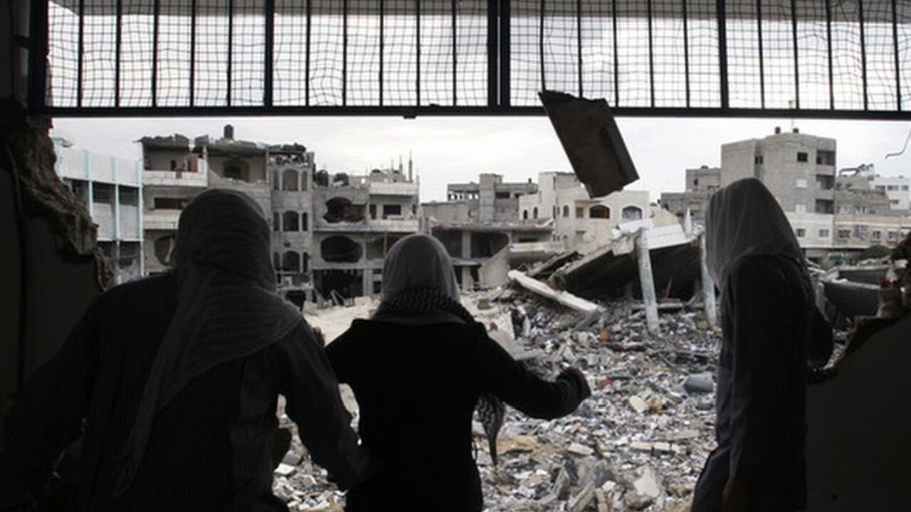 Palestinian school girls look at destroyed buildings from their school, which witnesses said was damaged in an Israeli air strike, in Gaza City Palestinian school girls look at destroyed buildings from their school, which witnesses said was damaged in an Israeli air strike, in Gaza City November 24, 2012. Israel eased restrictions on Gaza fishermen on Saturday, further implementing a three-day-old truce brokered by Egypt after a week of fierce fighting, Palestinian officials said. Hundreds of thousands of Palestinian children headed back to school for the first time in 10 days, in another indication normal life was returning after cross-border viol