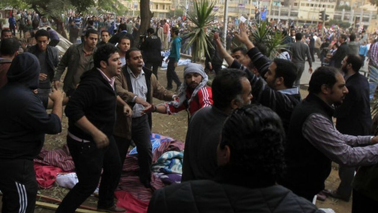 Muslim Brotherhood supporters of Egyptian President Mohammed Morsi fight with an anti-Morsi protester during clashes outside the presidential palace on December 5, 2012 in Cairo Muslim Brotherhood supporters of Egypt's President Mohammed Mursi fight with an anti-Morsi protester during clashes outside the presidential palace in Cairo December 5, 2012. Islamists fought protesters outside the Egyptian president's palace on Wednesday, while inside the building his deputy proposed a way to end a crisis over a draft constitution that has split the most populous Arab nation. REUTERS/Mohamed Abd El Ghany (EGYPT - Tags: POLITICS CIVIL UNREST)