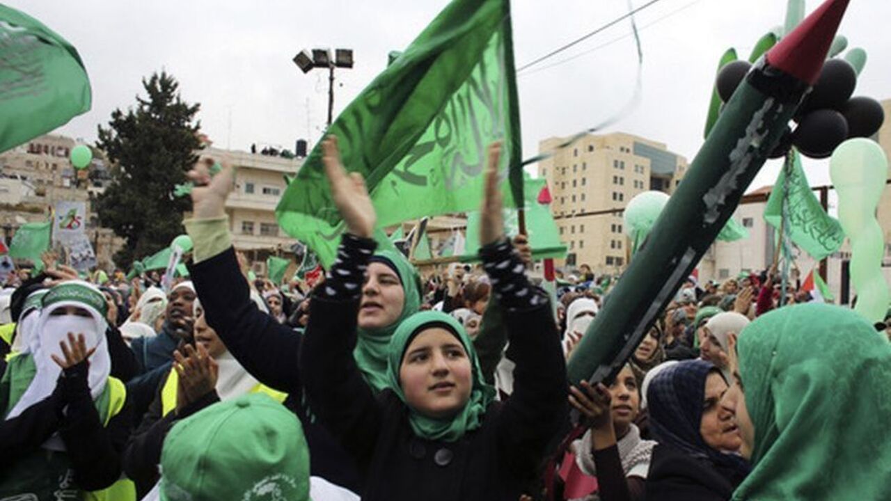 A supporter holds a model of a Hamas-made rocket as others wave flags during a rally in Hebron A supporter holds a model of a Hamas-made rocket as others wave flags during a rally in the West Bank city of Hebron, marking the 25th anniversary of the founding of Hamas, December 14, 2012. It was one of the first rallies Western-backed Palestinian President Mahmoud Abbas allowed to take place in the West Bank since 2007, when his Islamist rivals Hamas seized control of the Gaza Strip. REUTERS/Ammar Awad (WEST BANK - Tags: POLITICS ANNIVERSARY)