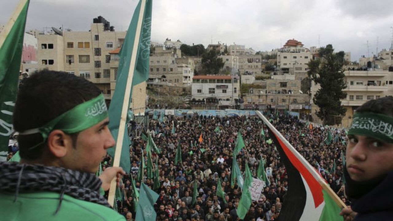 Hamas supporters wave flags during a rally in Hebron Hamas supporters wave flags during a rally in the West Bank city of Hebron, marking the 25th anniversary of the founding of the Islamist militant group, December 14, 2012. It was one of the first rallies Western-backed Palestinian President Mahmoud Abbas allowed to take place in the West Bank since 2007, when his Islamist rivals Hamas seized control of the Gaza Strip. REUTERS/Ammar Awad (WEST BANK - Tags: POLITICS ANNIVERSARY)